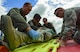 U.S. Air Force medical personnel from the 110th Bomb Squadron and the 37th Expeditionary Bomb Squadron, and firefighters, roll a volunteer onto a gurney during an exercise at Royal Air Force Fairford, U.K., June 13, 2017. Exercises involving multiple departments provide opportunities to increase interoperability and readiness. (U.S. Air Force photo by Airman 1st Class Randahl J. Jenson)