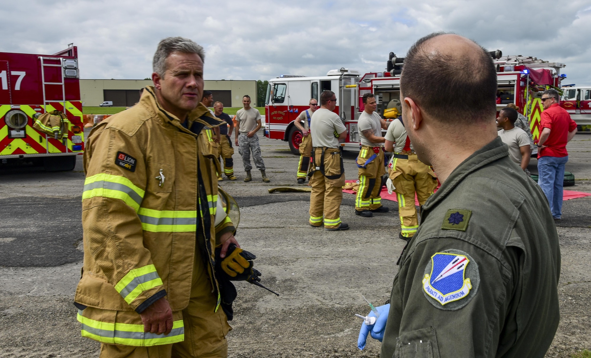 Trevor Daily, Royal Air Force assistant fire chief, debriefs with U.S. Air Force Lt. Col. Joseph Fugaro, 110th Bomb Squadron flight surgeon, after a medical exercise at RAF Fairford, U.K., June 13, 2017. Exercises like this increase interoperability between the two departments and prepare them to work together during real-life scenarios. (U.S. Air Force photo by Airman 1st Class Randahl J. Jenson)