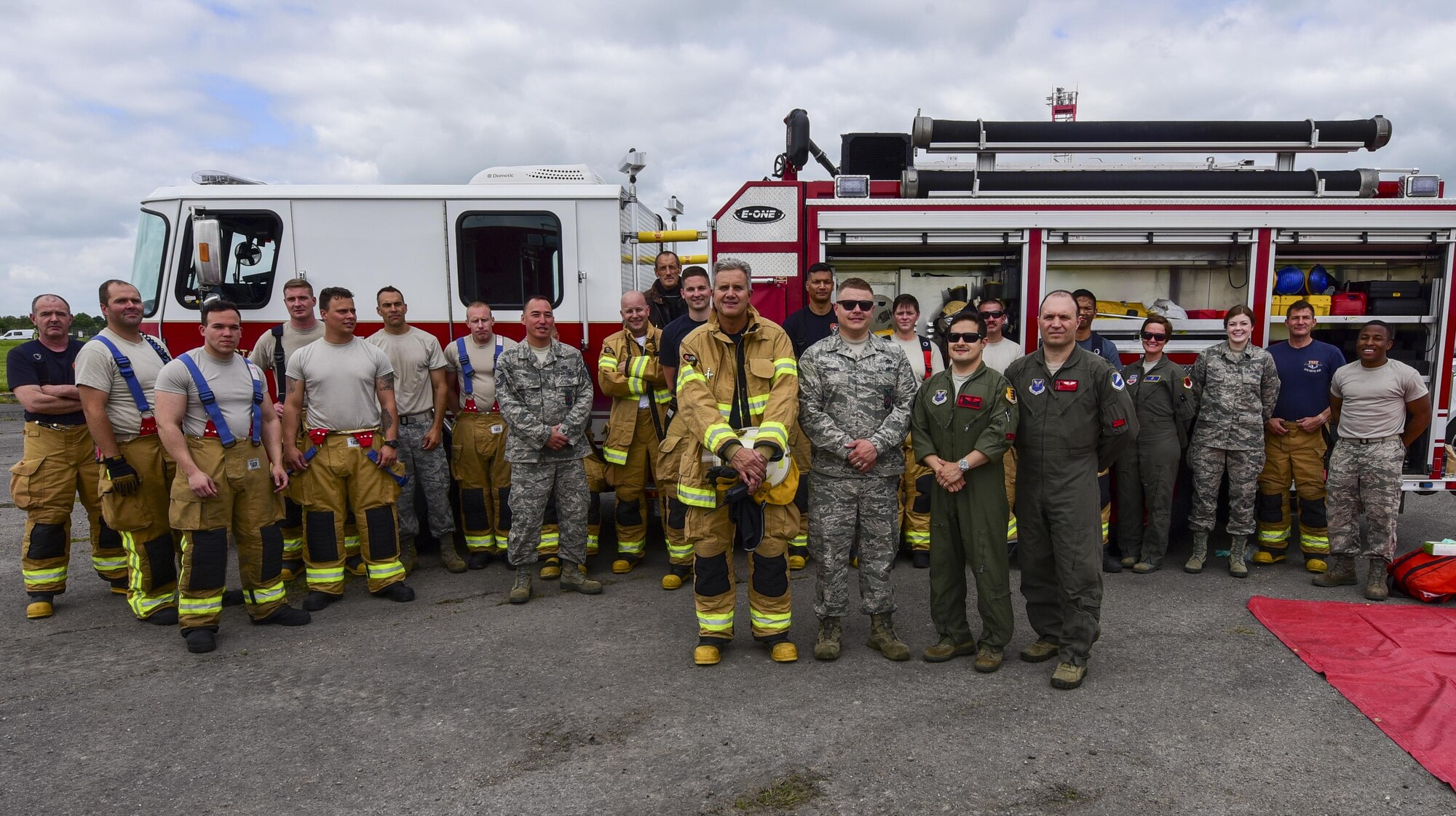 Royal Air Force Firefighters and U.S. Air Force Airmen stand together after a medical exercise at Royal Air Force Fairford, U.K., June 13, 2017. Exercises involving multiple departments provide opportunities to increase interoperability and readiness. (U.S. Air Force photo by Airman 1st Class Randahl J. Jenson)