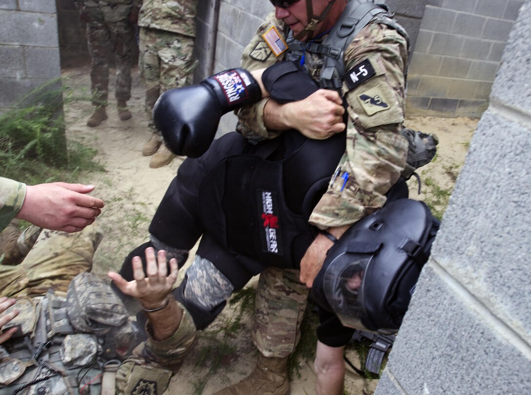 Sgt. David Blalock, a Cable Systems Installer-Maintainer representing the 75th Training Command, pulls simulated a combatant off of Sgt. Jonathan Anderson, a Combat Engineer representing the 83rd U.S. Army Reserve Readiness Center, during the Combat Skills Testing Lanes during the 2017 U.S. Army Reserve Best Warrior Competition at Fort Bragg, N.C. June 14. This year’s Best Warrior Competition will determine the top noncommissioned officer and junior enlisted Soldier who will represent the U.S. Army Reserve in the Department of the Army Best Warrior Competition later this year at Fort A.P. Hill, Va. (U.S. Army Reserve photo by Sgt. William A. Parsons) (Released)