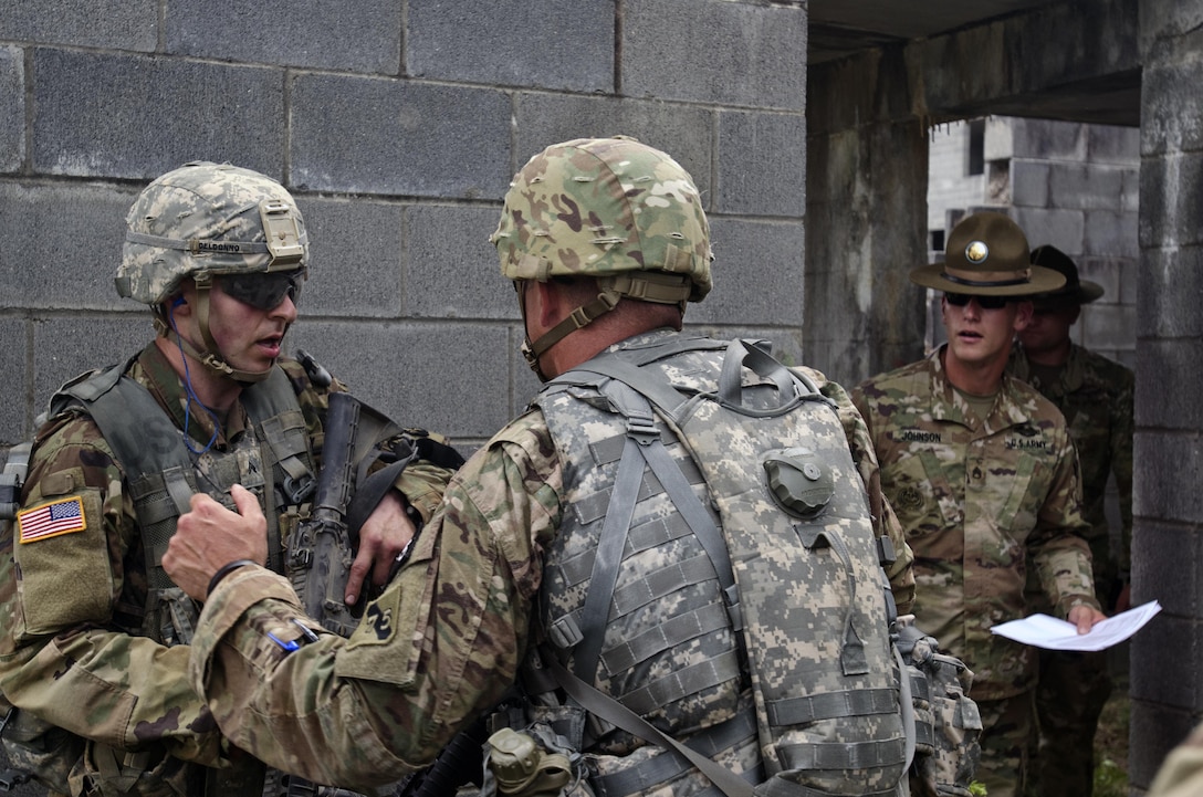 Sgt. David Blalock, a Cable Systems Installer-Maintainer representing the 75th Training Command, speaks with Cpl. Carlo Deldonno, a Healthcare Specialist representing the 3rd Medical Command (Deployment Support) after an intense close quarters struggle during the Combat Skills Testing Lanes the 2017 U.S. Army Reserve Best Warrior Competition at Fort Bragg, N.C. June 14. This year’s Best Warrior Competition will determine the top noncommissioned officer and junior enlisted Soldier who will represent the U.S. Army Reserve in the Department of the Army Best Warrior Competition later this year at Fort A.P. Hill, Va. (U.S. Army Reserve photo by Sgt. William A. Parsons) (Released)