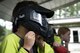 A competitor adjusts his mask before playing paintball at the Splatter Swamp Paintball course during Olympic Week, June 12, 2017, at Moody Air Force Base, Ga. Paintball was part of the Youth Center’s annual Olympic Week, with the goal of promoting unity and healthy lifestyles. (U.S. Air Force Photo by Airman 1st Class Erick Requadt) 
