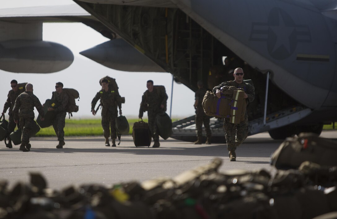 Marines with the Aviation Combat Element, Special Purpose Marine Air-Ground Task Force - Southern Command, exit a C-130 Hercules aircraft after arriving at Soto Cano Air Base, Honduras, May 28, 2017. The task force, comprised of approximately 300 Marines from both active and reserve components, is deploying to Belize, El Salvador, Guatemala and Honduras this summer to conduct engineering projects and build upon security cooperation efforts and established relationships in the region. (U.S. Marine Corps photo by Sgt. Ian Leones)
