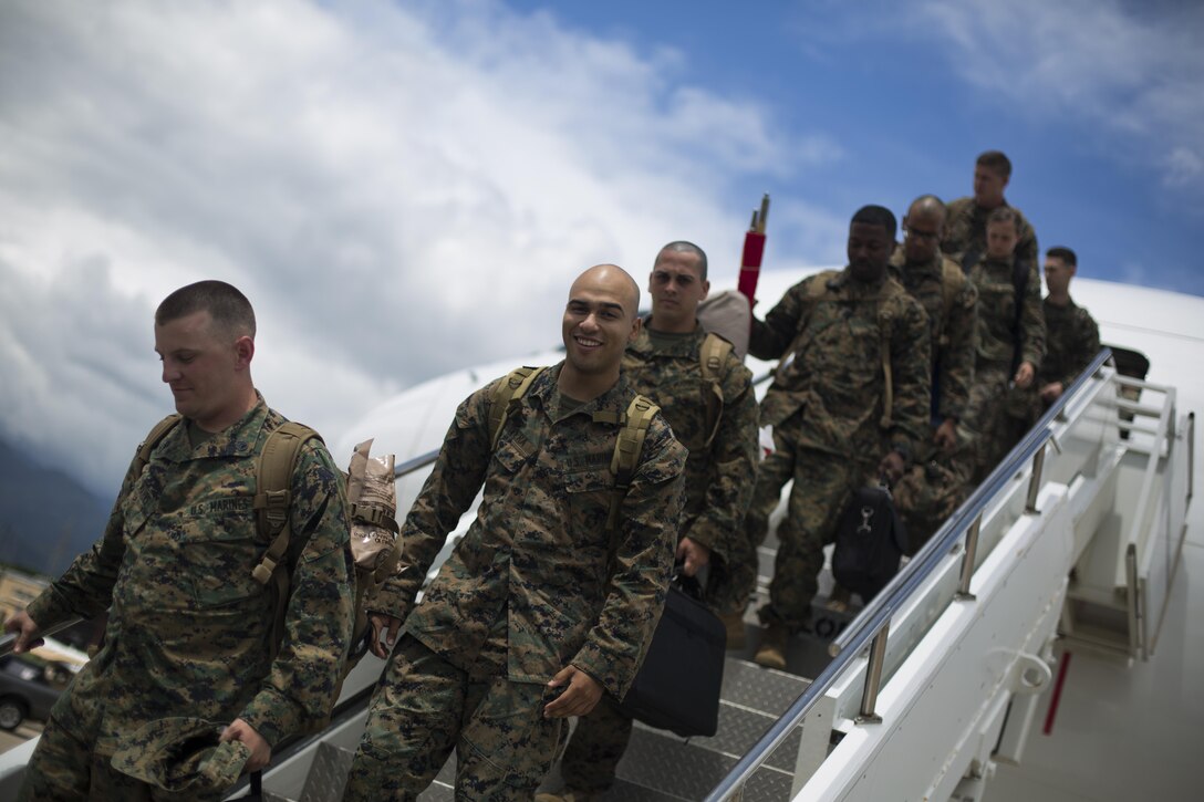 Marines with Special Purpose Marine Air-Ground Task Force - Southern Command exit a Boeing 767 charter aircraft after landing at Soto Cano Air Base, Honduras, June 1, 2017. The main body of SPMAGTF-SC arrived in Honduras to begin their six-month deployment in Central America. The task force, comprised of approximately 300 Marines from both active and reserve components, will operate in Belize, El Salvador, Guatemala and Honduras from June to November to conduct engineering projects and build upon security cooperation efforts and established relationships in the region. (U.S. Marine Corps photo by Sgt. Ian Leones)