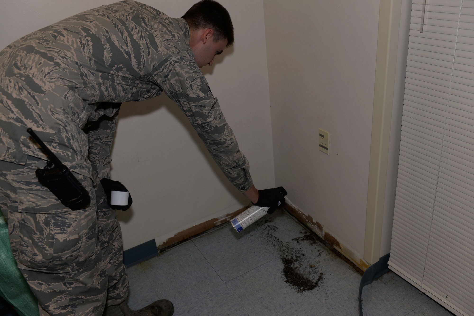 Airman 1st Class Alexander Smith, 19th Civil Engineering Squadron Pest Management technician, sprays pesticides for Carpenter Ants May 3, 2017, at Little Rock Air Force Base.  Carpenter Ants prefer wood that’s damp, such as that around windows or doors. (U.S. Air Force photo by Airman Rhett Isbell)