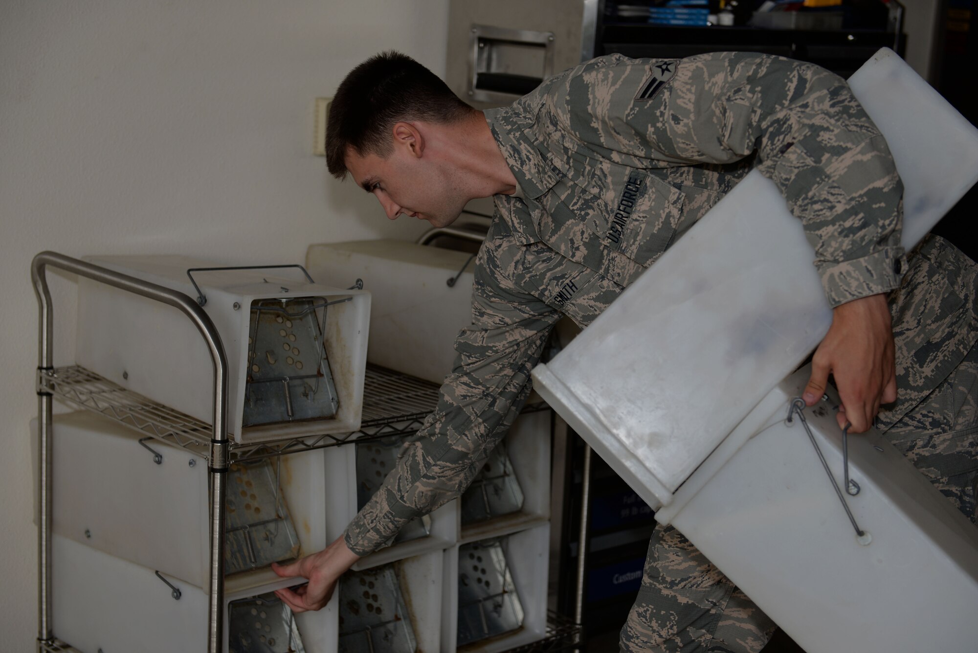 Airman 1st Class Alexander Smith, 19th Civil Engineering Squadron Pest Management technician, grabs live-capture traps to use on a work call May 3, 2017, at Little Rock Air Force Base. The plastic live-capture cages are closed off so captured skunks can’t spray individuals from inside the cage. (U.S. Air Force photo by Airman Rhett Isbell)