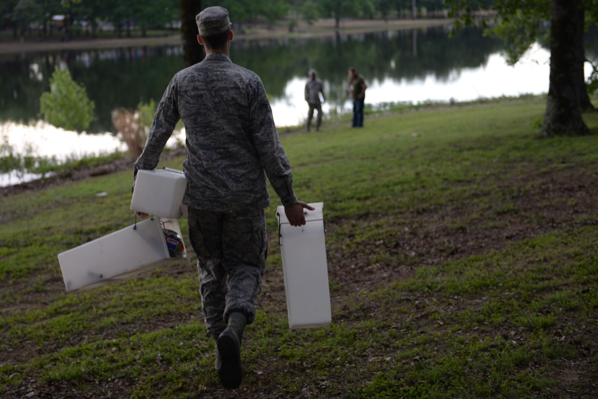 Airman 1st Class Alexander Smith, 19th Civil Engineering Squadron pest management technician, brings live-capture traps to the edge of the Little Rock Air Force Base lake May 3, 2017. Animals tend to hide by walking along the edges of the lake. (U.S. Air Force photo by Airman Rhett Isbell)