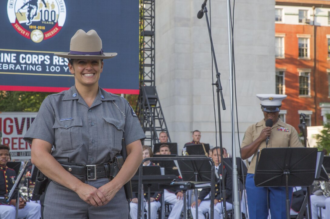 Trooper Kristen Erario, a recruitment officer with the New York State Police and a gunnery sergeant in the Marine Corps Reserve, accepts a certificate of appreciation on behalf of the New York State Police at Washington Square Park in New York, June 14, 2017. Reserve Marines serve to protect our nation while also balancing responsibilities of family, school, community and careers. (U.S. Marine Corps photo by Lance Cpl. Niles Lee/Released) 