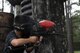 A competitor fires from behind cover at the Splatter Swamp Paintball course during Olympic Week, June 12, 2017, at Moody Air Force Base, Ga. Paintball was part of the Youth Center’s annual Olympic Week, with the goal of promoting unity and healthy lifestyles. (U.S. Air Force Photo by Airman 1st Class Erick Requadt)