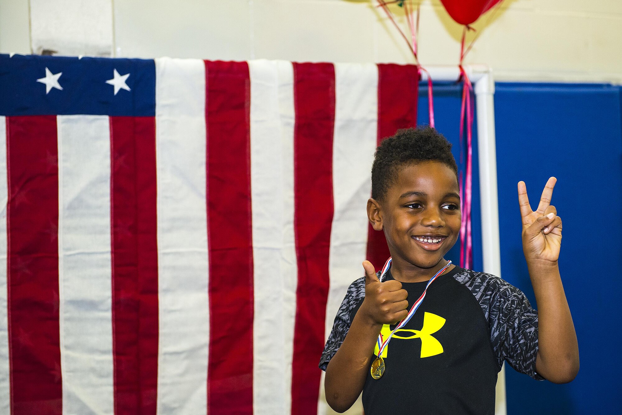 Morrecus, son of Master Sgt. Tiffany Jackson-Foster, 23d Logistics Readiness Squadron transportation management office superintendent, smiles after receiving a medal at the end of Olympic Day in the Youth Center during Olympic Week, June 15, 2017, at Moody Air Force Base, Ga. Every participant received a medal for taking part in the Youth Center’s annual Olympic Week, which was designed to promote unity and healthy lifestyles. (U.S. Air Force Photo by Airman 1st Class Erick Requadt)

