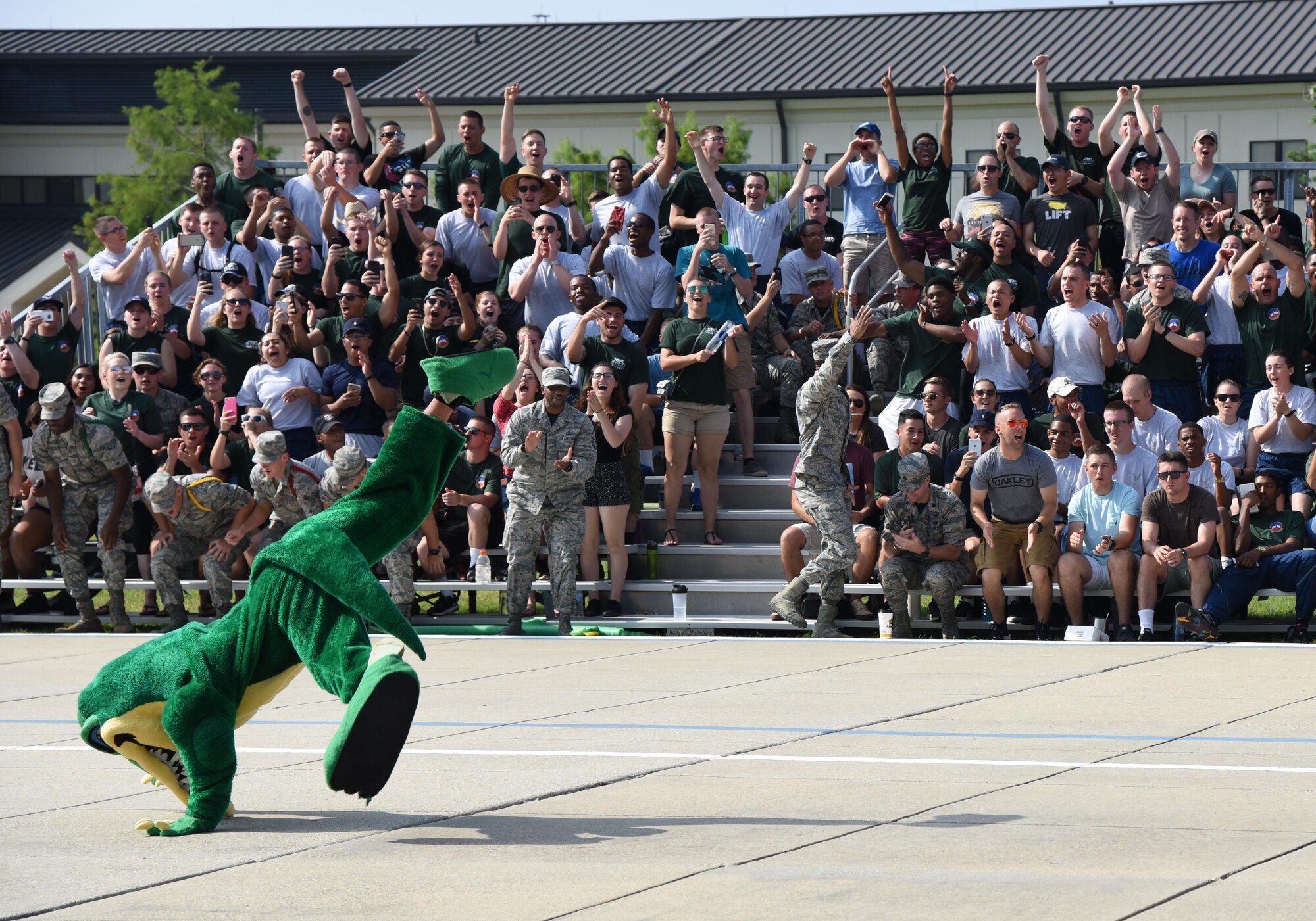 Airmen from 334th Training Squadron cheer for their drill team during the 81st Training Group drill down on the Levitow Training Support Facility drill pad June 16, 2017, on Keesler Air Force Base, Miss. Airmen from the 81st TRG competed in a quarterly open ranks inspection, regulation drill routine and freestyle drill routine. The 334th TRS “Gators” took first place this quarter. (U.S. Air Force photo by Kemberly Groue)