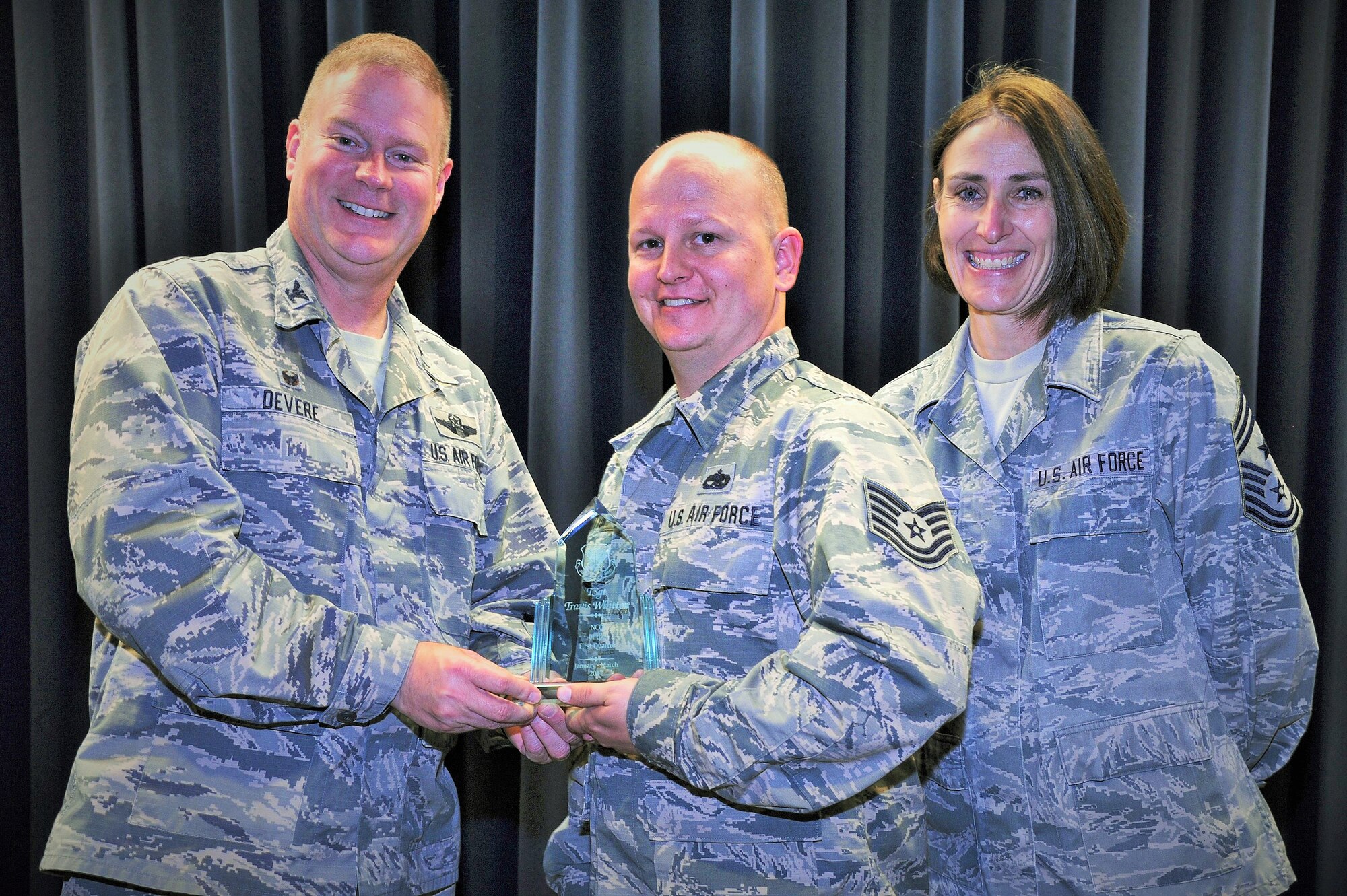 Tech. Sgt. Travis Whitton, 302nd Maintenance Squadron, receives the 302nd Airlift Wing’s 2017 1st Quarter award in the NCO category from Col. James DeVere, 302nd Airlift Wing commander, and Chief Master Sgt. Vicki Robertson, 302nd AW command chief, during a ceremony at Peterson Air Force Base, Colo., June 4, 2017. As part of the Reserve wing’s quarterly awards program, Citizen Airmen are nominated for excellence in leadership, job performance, significant self-improvement and contributions to their on and off-base communities. The other 2017 First Quarter Award winners are: Airman 1st Class Kwesi Hanson, 302nd Logistics Readiness Squadron, Airman category, Senior Master Sgt. Mark Skarban, 302nd Operations Support Squadron, Senior NCO category, Capt. Ashlea Garcia, 302nd Operations Support Squadron, company grade officer category, Lt. Col. Heather Lyons, 302nd Operations Group, field grade officer category.   (U.S. Air Force photo/1st Lt. Stephen J. Collier)