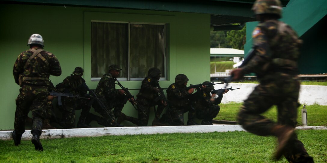 Trinidad and Tobago - Belize Defence Force soldiers take cover while conducting a simulated aerial and maritime raid during Exercise Tradewinds 2017 Phase II in Chaguaramas, Trinidad and Tobago, June 13, 2017. Tradewinds, an annual U.S. Southern Command-sponsored exercise, brings together 20 partner nations to increase Caribbean security and the combined ability to counter transnational terrorism and organize crime, and enhance humanitarian and disaster relief capabilities. (U.S. Marine Corps photo by Sgt. Olivia McDonald)