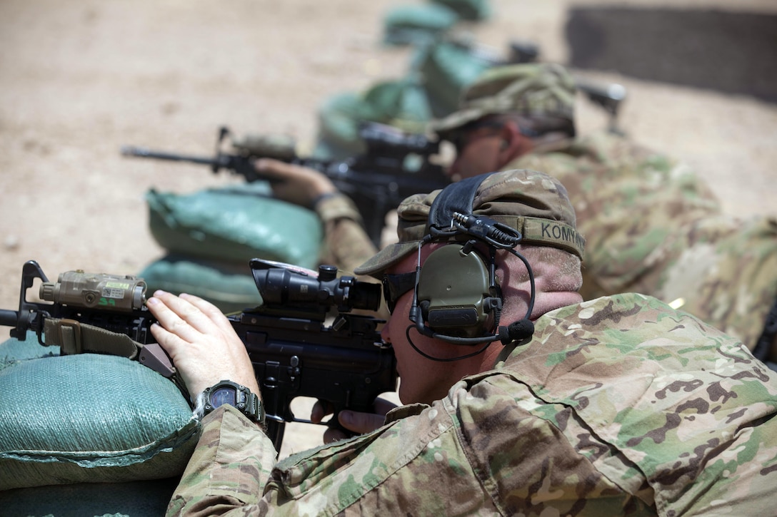 Army Sgt. Kurt Komyati, foreground, fires his M4 carbine alongside Army Command Sgt. Maj. Randolph Delapena at a range at Qayyarah West Airfield, Iraq, June 10, 2017. Komyati is deployed in support of Combined Joint Task Force Operation Inherent Resolve and assigned to the 2nd Brigade Combat Team, 82nd Airborne Division, and Delapena is the incoming 2nd BCT command sergeant major. Army photo by Cpl. Rachel Diehm

