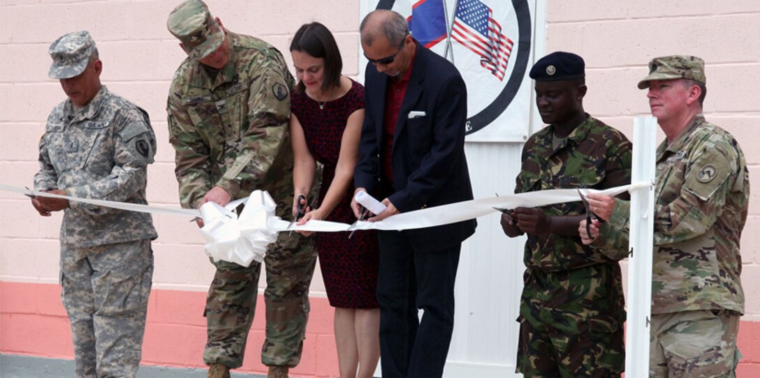 Completion of the new building at the Ladyville Health Clinic is officially marked at the ribbon-cutting ceremony June 9 in Ladyville, Belize. Shown cutting the ribbon (from left): Chief Warrant Officer 3 Herminio Romero, site project manager and member of the 448th Engineer Battalion from Puerto Rico; Col. John Simma, Beyond the Horizon 2017 Task Force Jaguar commander; Adrienne Galanek, Chargé d’Affaires for the U.S. Embassy Belize; Ramon Figueroa, CEO of the Belize Ministry of Health; Lance Cpl. Gladden of the Belize Defence Force and Lt. Col. Robert Ramsey, Senior Defense Official and Defense Attaché for the U.S. Embassy. Construction was accomplished during Beyond the Horizon 2017, a collaborative training event between U.S. Army South, the Belize Defence Force, other Central American nations and local and international NGOs, providing medical and engineering services throughout Belize.