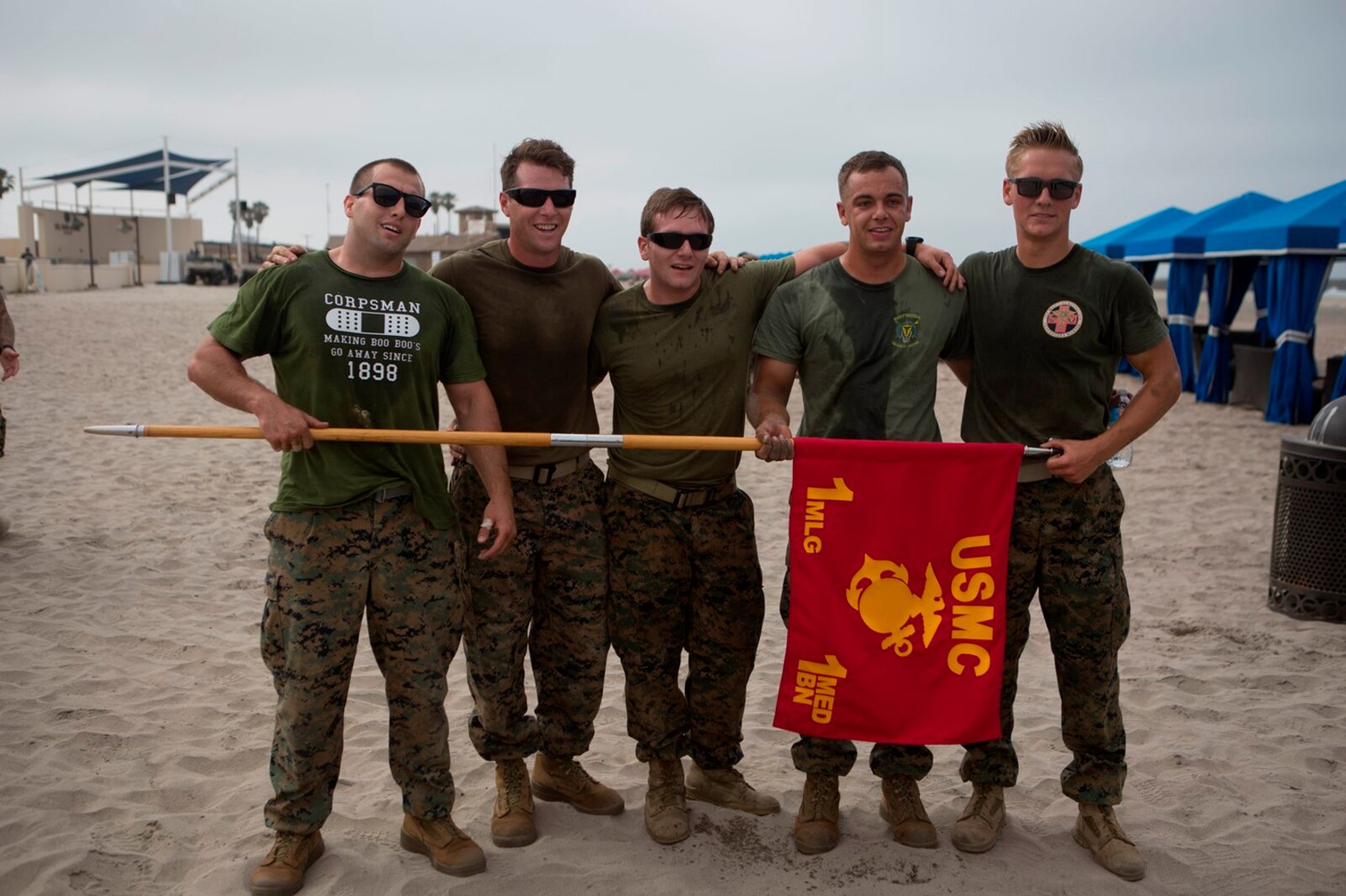 U.S. Navy (from left to right) Petty Officer Third Class John Jessie, Stefan Herrstrom, Jarrett Orich, Cody Carroll and Petty Officer Second Class Stephen Henderson, Corpsmen with 1st Medical Battalion, 1st Marine Logistics Group, pose with their unit guidon after completing the North County Corpsman Cup on Camp Pendleton, Calif., June 16, 2017. The North County Corpsman Cup is designed to test the knowledge, physical readiness and teamwork of each participating sailor while promoting esprit de corps among the Hospital Corpsman community. (U.S. Marine Corps photo by Lance Cpl. Joseph Sorci)