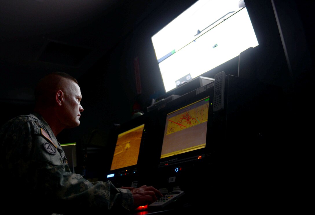 U.S. Army Staff Sgt. Mario Volmer, a range operator assigned to the South Dakota Army National Guard Training Center, programs obstacles for Ellsworth Airmen training in the virtual convoy at Camp Rapid, S.D., June 15, 2017. The virtual convoy is a multiple-station simulator that presents real-world convoy scenarios that Soldiers and Airmen may face overseas in contingency operations. (U.S. Air Force photo by Airman 1st Class Donald C. Knechtel)