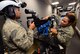 U.S. Air Force Staff Sgt. Jessica Gluth, an emergency management journeyman assigned to the 28th Civil Engineer Squadron, Ellsworth Air Force Base, S.D., explains the gunner position of a virtual convoy trainer to U.S. Air Force Airmen 1st Class Joshua Torres, a power production journeyman assigned to the 28th CES, at Camp Rapid, S.D., June 15, 2017. The virtual convoy trainer is housed inside a trailer and consists of four Humvee stations, each with a place for a driver and gunner. (U.S. Air Force photo by Airman 1st Class Donald C. Knechtel)