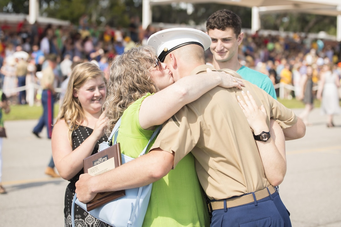 Glenda McCool, mother of Marine Corps Pfc. Sean G. McCool, kisses her son after he is dismissed by his senior drill instructor following graduation from training at Marine Corps Recruit Depot Parris Island, S.C., June 9, 2017. The seventh Marine in his family, McCool earned the distinction of being his platoon's honor graduate. Marine Corps photo by Lance Cpl. Joseph Jacob