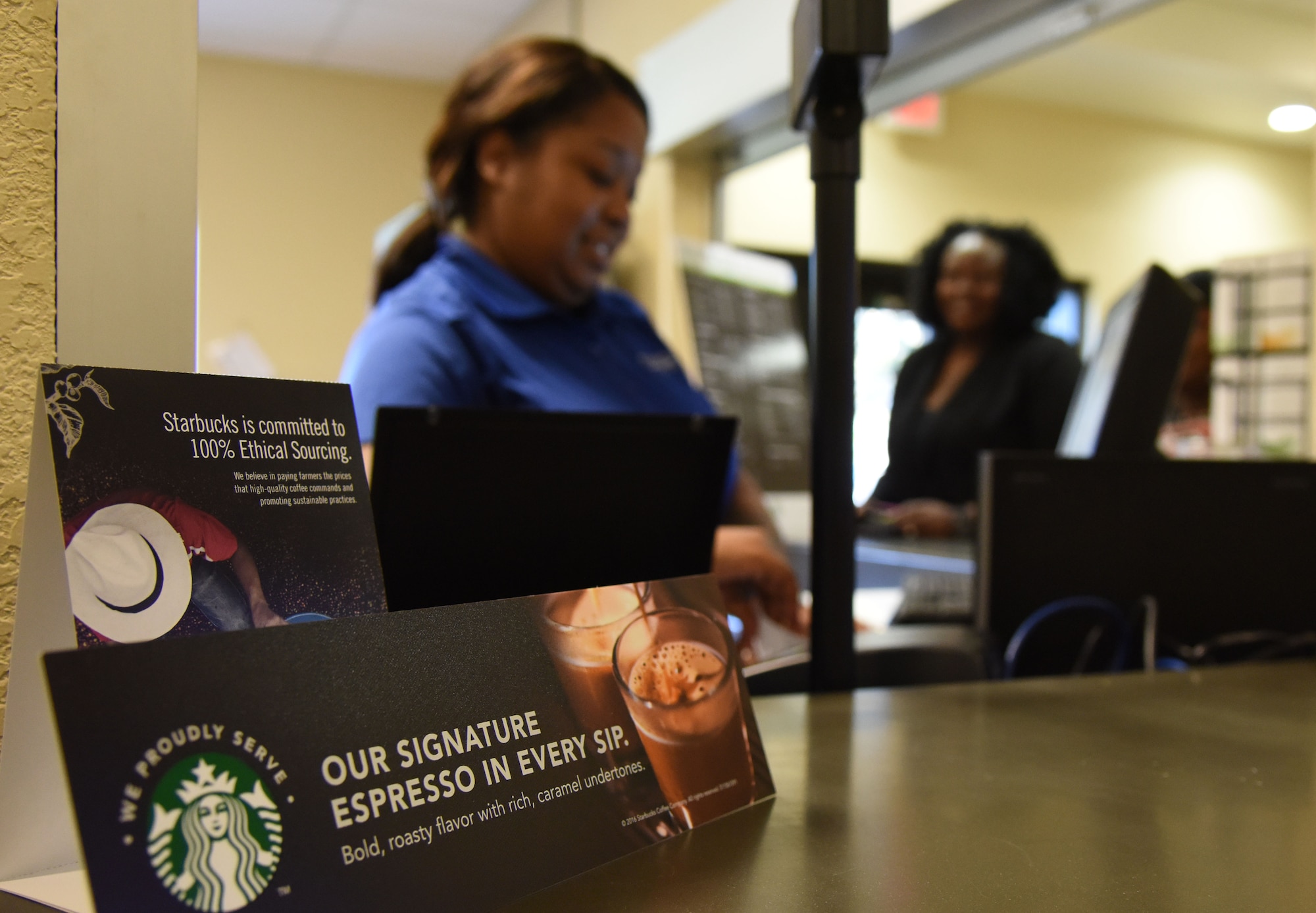 Teaunda Rodgers, 81st Force Support Squadron sales clerk, rings up a customer at “It Is In The Cup” in the Bay Breeze Event Center June 8, 2017, on Keesler Air Force Base, Miss. Keesler's new coffee & smoothie bar will have its grand opening on June 29 at the Bay Breeze Event Center. The facility proudly serves Starbucks coffee, Frappuccino’s, iced beverages and espresso as well as Island Oasis smoothies in a variety of flavors. A full menu of items can be found at keesler81fss.us. (U.S. Air Force photo by Kemberly Groue)