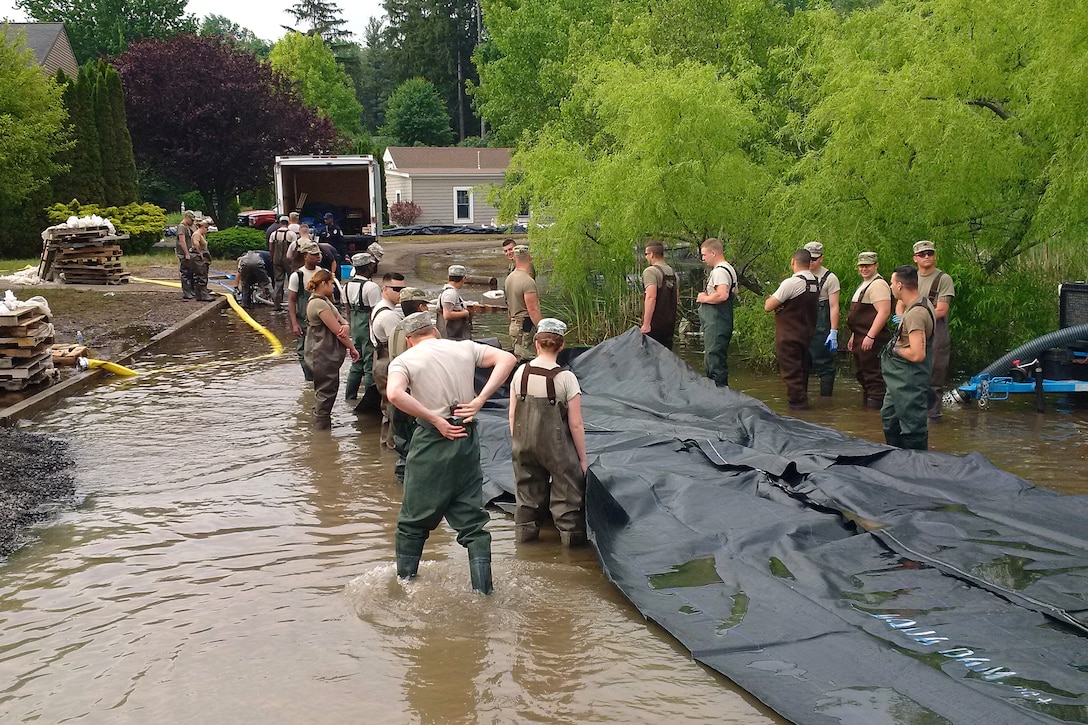 New York Army National Guardsmen deploy an AquaDam, a water-filled cofferdam, to control Lake Ontario’s high water levels at Sodus Point, N.Y., June 13, 2017. The lake is almost three feet higher than normal, which is causing flooding. New York Army and Air National Guardsmen have been on duty assisting in flood control efforts since May 3 at the direction of Gov. Andrew M. Cuomo. New York Army National Guard photo by Brig. Gen. Ray Shields