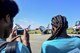 High School students from Inspiring Minds (IM) watch as IM founder and CEO, Deryck Toles, taxis in a U.S. Air Force Thunderbird F-16 here, June 16, 2017. Toles was selected as the Thunderbirds' Hometown Hero and received an orientation flight before the 2017 Thunder Over the Valley Air Show. IM is a youth organization that exists to engage, inspire and empower youth to reach their full potential through education and exposure to life-changing experiences. (U.S. Air Force photo/Senior Airman Jeff Grossi)