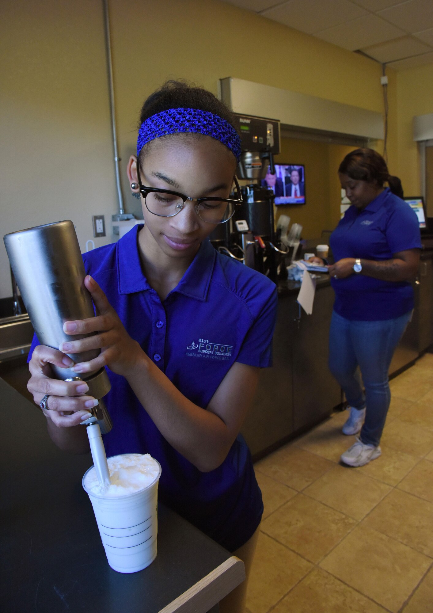 Quiana James and Teaunda Rodgers, 81st Force Support Squadron sales clerks, prepares orders at “It Is In The Cup” in the Bay Breeze Event Center June 8, 2017, on Keesler Air Force Base, Miss. Keesler's new coffee & smoothie bar will have its grand opening on June 29 at the Bay Breeze Event Center. The facility proudly serves Starbucks coffee, Frappuccino’s, iced beverages and espresso as well as Island Oasis smoothies in a variety of flavors. A full menu of items can be found at keesler81fss.us. (U.S. Air Force photo by Kemberly Groue)