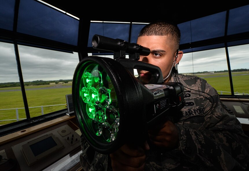 Tech. Sgt. Jason Medina, 5th Operations Support Squadron air traffic controller watch supervisor, operates a light gun at Royal Air Force Fairford, United Kingdom, June 10, 2017. A team of four air traffic controllers from across the globe assembled to work with seven different airframes in support of multi-national, large-scale exercises Arctic Challenge, BALTOPS 17 and Saber Strike 17. Allies and partner nations rely on common tactics, techniques, and procedures that enable them to quickly combine as an effective fighting force. Forces that participate in these exercise leave with a higher state of readiness, improved interoperability with forces from NATO and partner nations, and confidence in their ability to operate together in a time of crisis. (U.S. Air Force photo/Senior Airman Curt Beach)