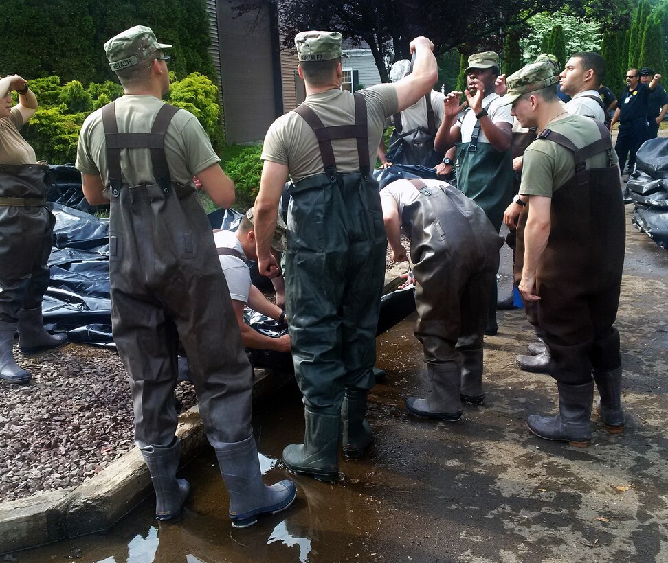 New York Army National Guardsmen discuss the placement of an AquaDam, a water-filled cofferdam, to control Lake Ontario’s high water levels at Sodus Point, N.Y., June 13, 2017. New York Army National Guard photo by Brig. Gen. Patrick Center