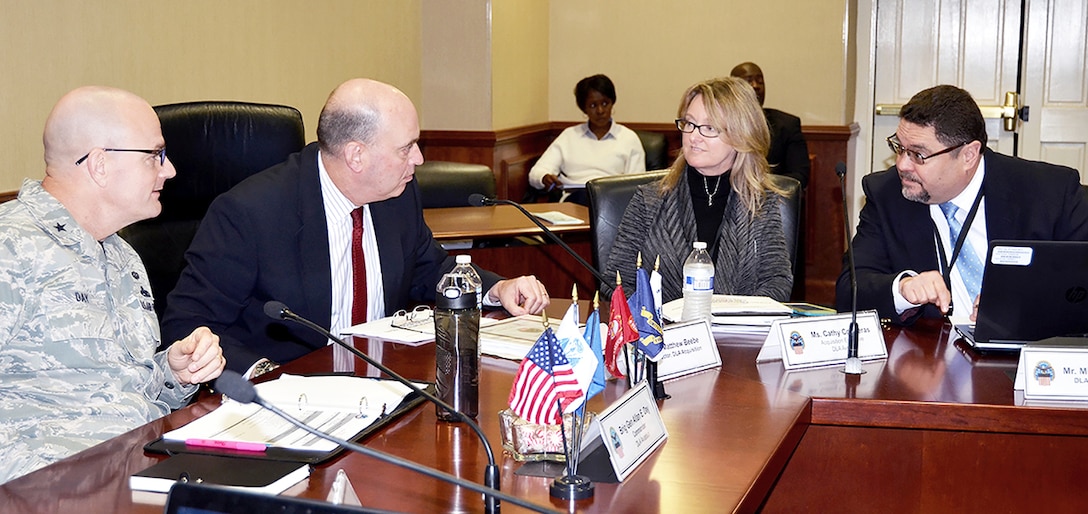 Cathy Contreras, Defense Logistics Agency Aviation’s acquisition executive and head of contracting agency, discusses acquisition policies with Matthew Beebe, DLA Headquarters Acquisitions director, former DLA Aviation Commander Air Force Brig. Gen. Allan Day, and Miquel Zayas, far right, supervisory procurement analyst, DLA Headquarters Acquisitions, March 10, 2017 during an Agency Management Review March 6 – 10, 2017 at Defense Supply Center Richmond, Virginia. 