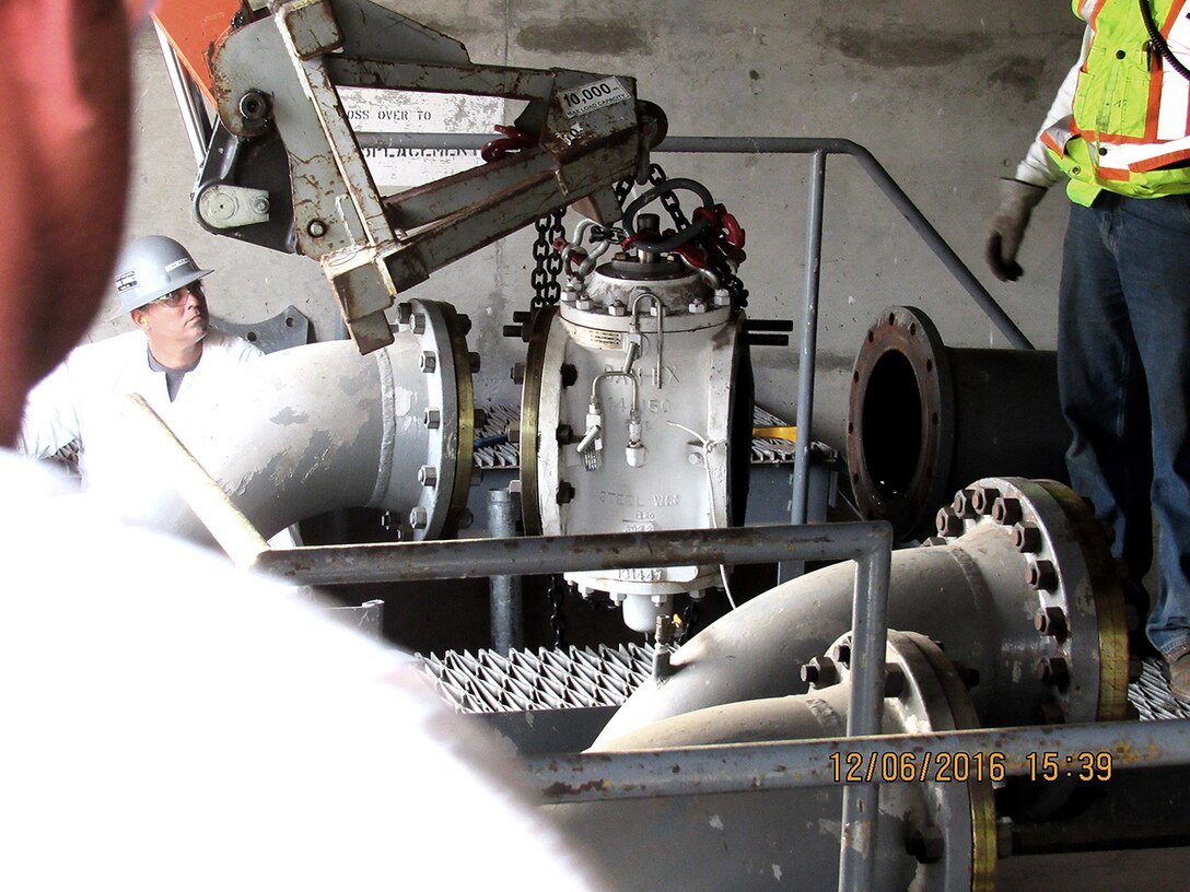 Workers remove a 14-inch double-block and bleed valve as part of DLA’s closure of Defense Fuel Support Point San Pedro.