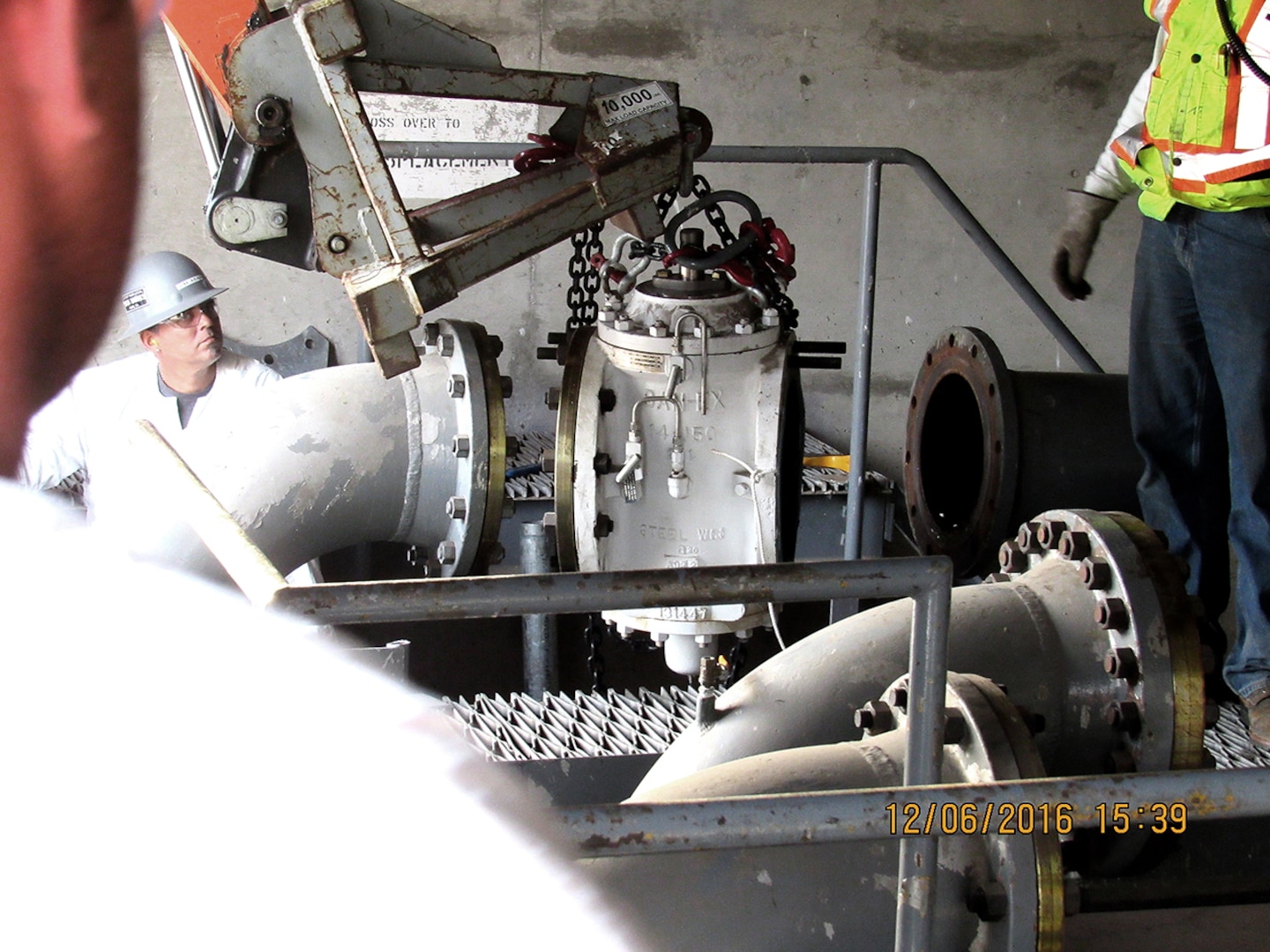 Workers remove a 14-inch double-block and bleed valve as part of DLA’s closure of Defense Fuel Support Point San Pedro.