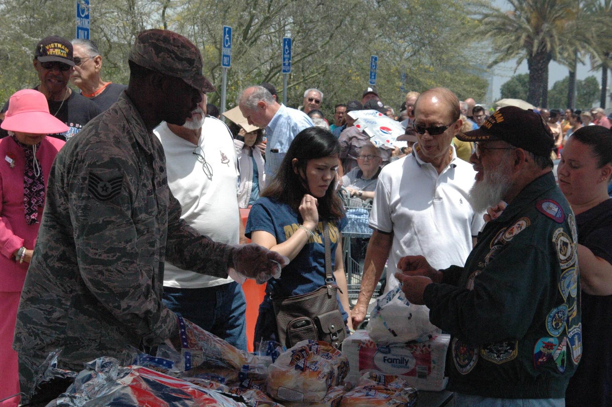Tech. Sgt. Gregory Reid from the 61st Communications Squadron and a volunteer with the “Rising Six” service group at the Space and Missile Systems Center, prepares to serve the first of nearly 750 attendees during a “Burger Burn” as part of the annual Armed Forces Retiree Appreciation Day, June 3, 2017, at Los Angeles Air Force Base in El Segundo, California. (U.S. Air Force photo/ James Spellman, Jr.)