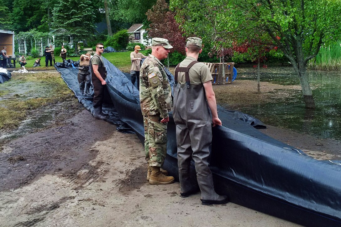 New York Army National Guardsmen prepare to deploy an AquaDam, a water-filled cofferdam, to control Lake Ontario’s high water levels at Sodus Point, N.Y., June 13, 2017. New York Army National Guard photo by Brig. Gen. Patrick Center