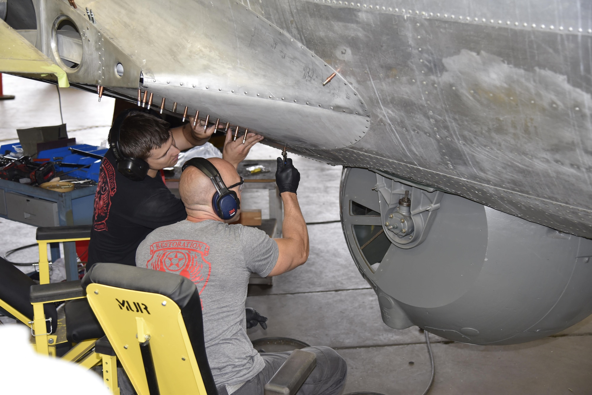 DAYTON, Ohio (06/2017) -- (From left to right) Restoration Specialists Jason Davis and Chase Meredith work on the B-17F "Memphis Belle"™ in the restoration hangar at the National Museum of the U.S. Air Force. The exhibit opening for this aircraft is planned for May 17, 2018.(U.S. Air Force photo by Ken LaRock)