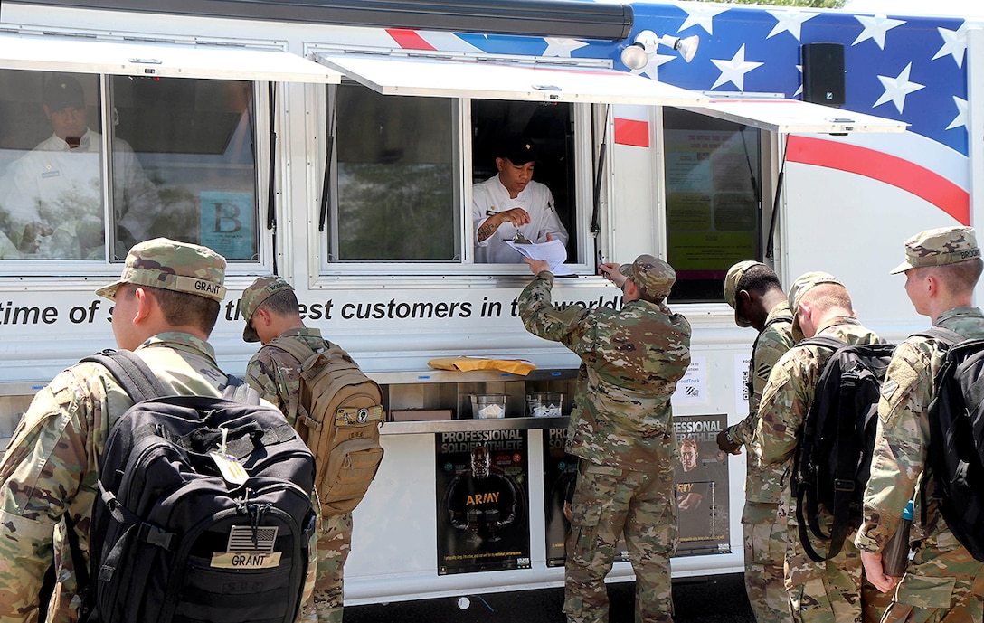 Soldiers from the Marne Reception Center put in their lunch orders at the Outpost food truck and wait to be served. The food truck is a convenient way for soldiers to get chow on the go.