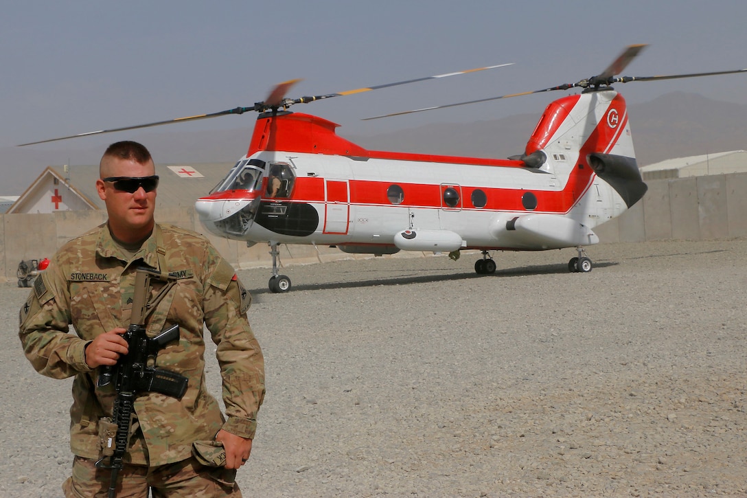 Sgt. Ian Stoneback a Cavalry Scout with B troop, 6th Squadron, 1st Cavalry Regiment, 1st Armored Division ensures that no one comes onto the helicopter landing zone as aircraft land on Advising Platform Lightning Apr 13. Soldiers on AP Lightning perform multiple jobs over and above the Train, Advise and Assist missions.  (U.S. Army photo provided by Sgt. Christopher B. Dennis, 1st Cavalry Division PAO. Photo edited for security purposes.)