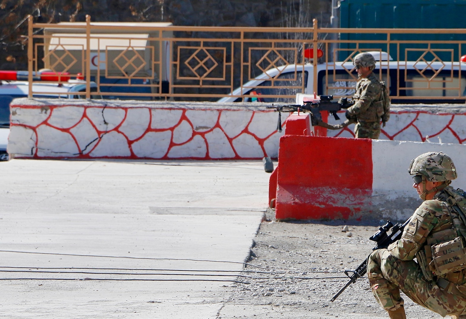 Spc. Matthew Mccullough (background) and Pfc. Nathan Petty (foreground) Cavalry Scouts with B troop, 6th Squadron, 1st Cavalry Regiment, 1st Armored Division pull security Mar. 14 at 303rd Zone Police Headquarters, in Gardez, Afghanistan. “Blackfoot” troop act as Guardian Angels for Advisors during Train Advise and Assist Missions to the 303rd Police Headquarters Zone. (U.S. Army photo provided by Sgt. Christopher B. Dennis, 1st Cavalry Division PAO.)