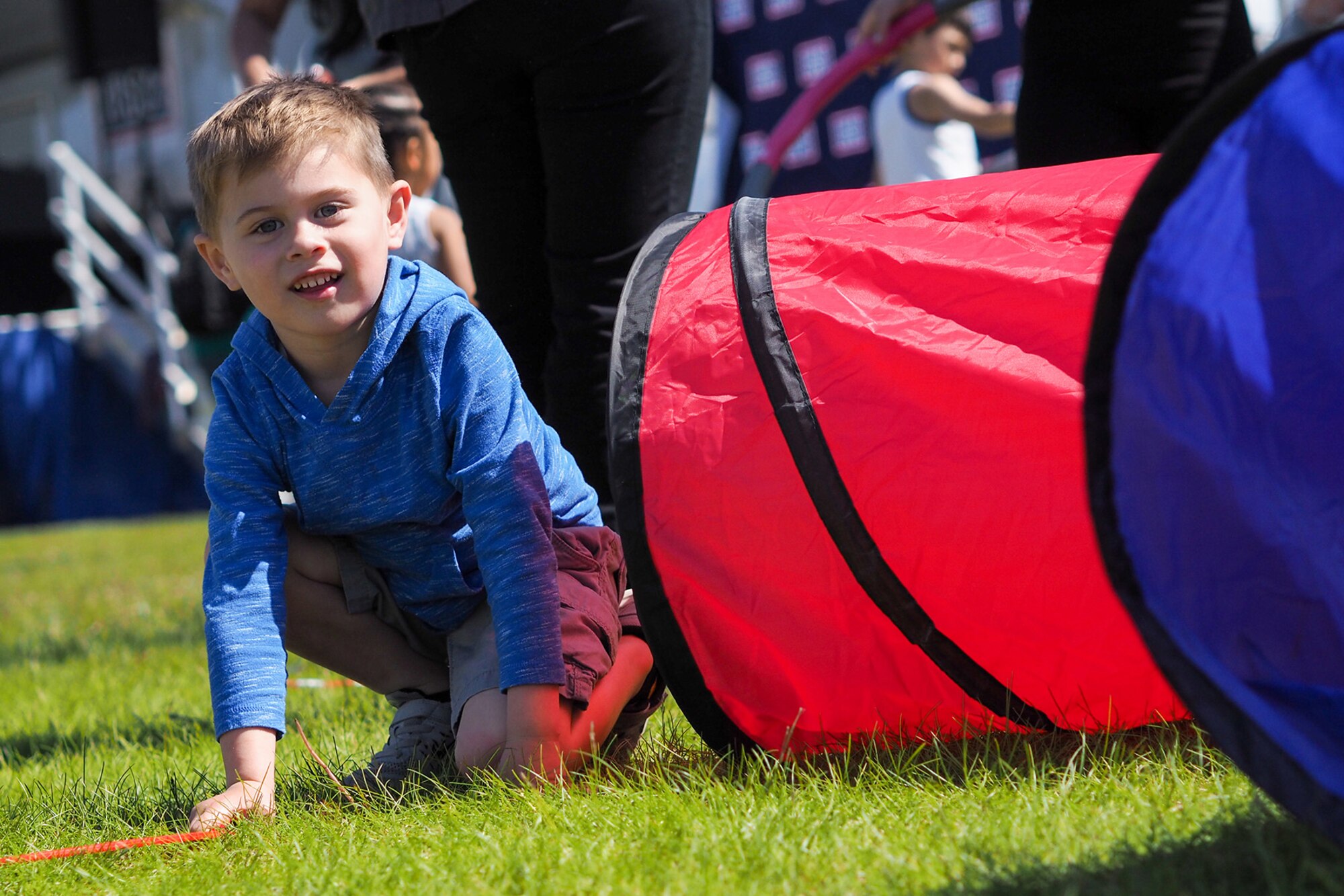 Adam Gutierrez, 4, climbs out of a play tunnel a service members, dependents, and Department of Defense civilians attend the Military Appreciation Week picnic at the Joint Base Elmendorf-Richardson, Alaska, Buckner Fitness Center fields June 16, 2017. Several organizations came together to provide a variety of family-fun activities such as competitive sporting events for the adults, face painting and bouncy houses for the children in addition to the Anchorage Chamber of Commerce-provided food and music during the annual event.