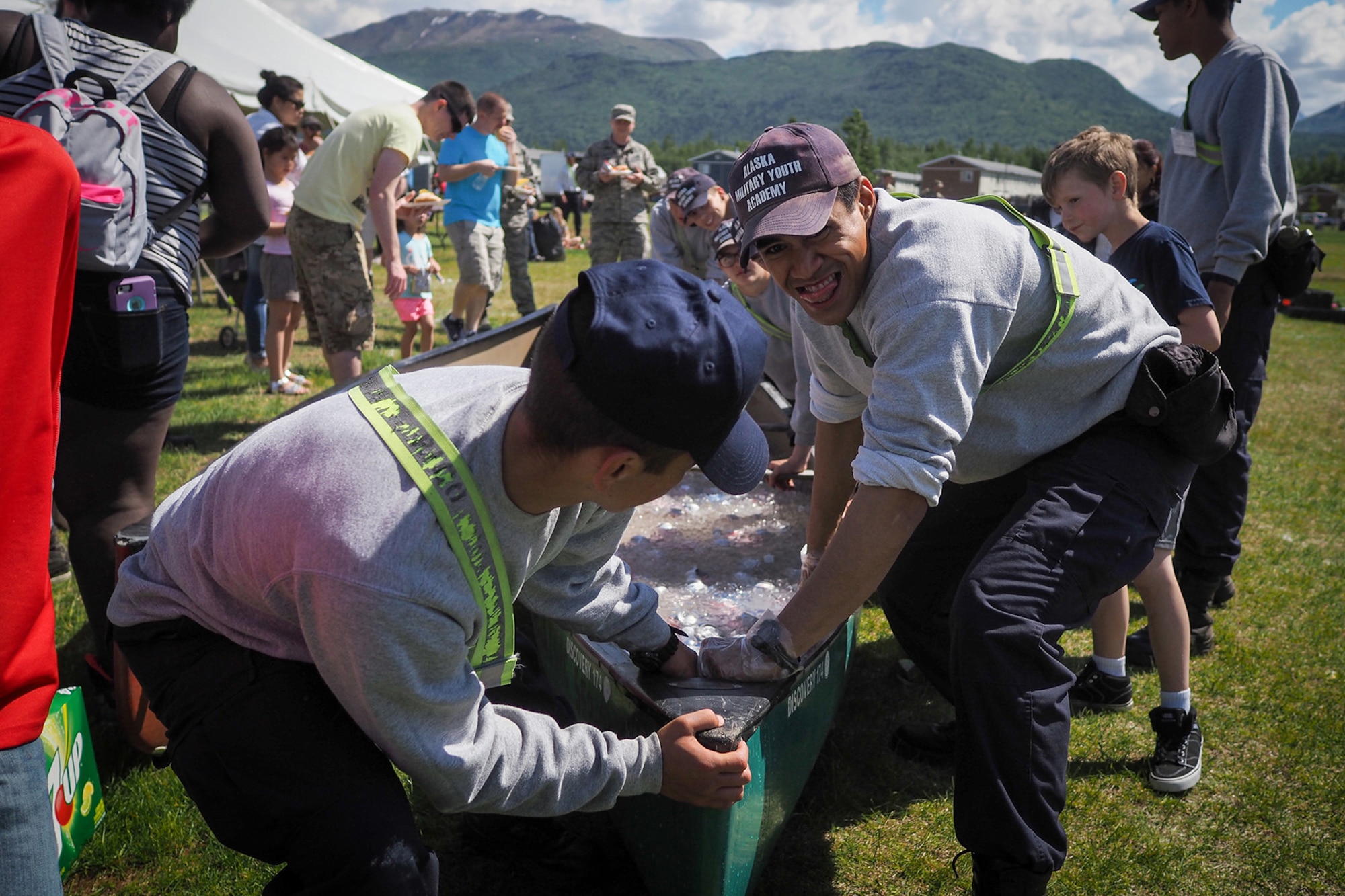 Alaska Military Youth Academy members Brennan Rico, left, and Toa Toluono help move a canoe loaded with ice and soft drinks as Service members, dependents, and Department of Defense civilians attend the Military Appreciation Week picnic at the Joint Base Elmendorf-Richardson, Alaska, Buckner Fitness Center fields June 16, 2017. Several organizations came together to provide a variety of family-fun activities such as competitive sporting events for the adults, face painting and bouncy houses for the children in addition to the Anchorage Chamber of Commerce-provided food and music during the annual event.