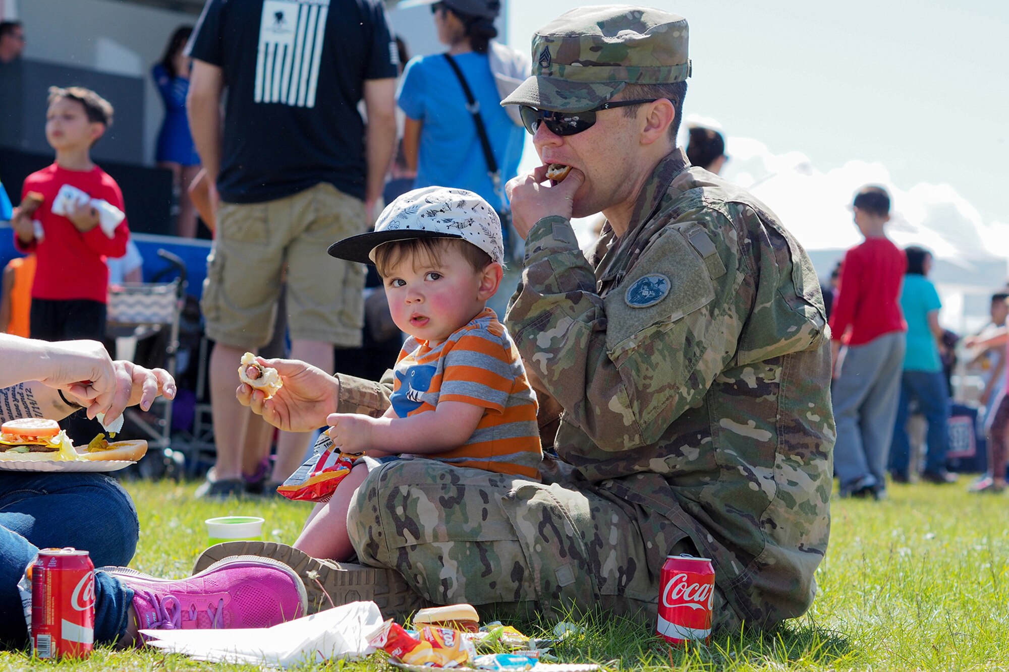 Army Staff Sgt. David Riley, assigned to the 109th Transportation Company, 17th Combat Sustainment Support Battalion, U.S. Army Alaska, holds his son Finley Riley, 18-months-old, at the annual Military Appreciation Week picnic at the Joint Base Elmendorf-Richardson, Alaska, Buckner Fitness Center fields June 16, 2017.  Several organizations came together to provide a variety of family-fun activities such as competitive sporting events for the adults, face painting and bouncy houses for the children in addition to the Anchorage Chamber of Commerce-provided food and music during the annual event.