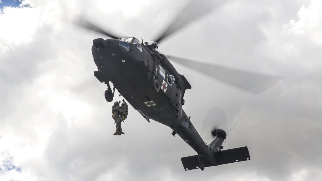 Soldiers hoist a simulated wounded soldier into an HH60-M Medevac Blackhawk during the Golden Coyote training exercise in Belle Fourche Reservoir, S.D., June 19, 2017. The scenario-driven exercise enables commanders to focus on warrior tasks and battle drills. The soldiers are assigned to Company C, 1st Battalion, 189th Aviation Regiment, South Dakota Army National Guard. Army photo by Spc. Mitchell Murphy