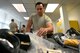 U.S. Air Force Airman 1st Class Alejandro Irazarry Zaharis, 20th Operations Support Squadron aircrew flight equipment (AFE) technician, prepares a survival kit at Shaw Air Force Base, S.C., June 20, 2017. The survival kits, utilized by pilots upon emergency ejection from an aircraft, can hold numerous items to include water, candles and flares. (U.S. Air Force photo by Airman 1st Class Christopher Maldonado)