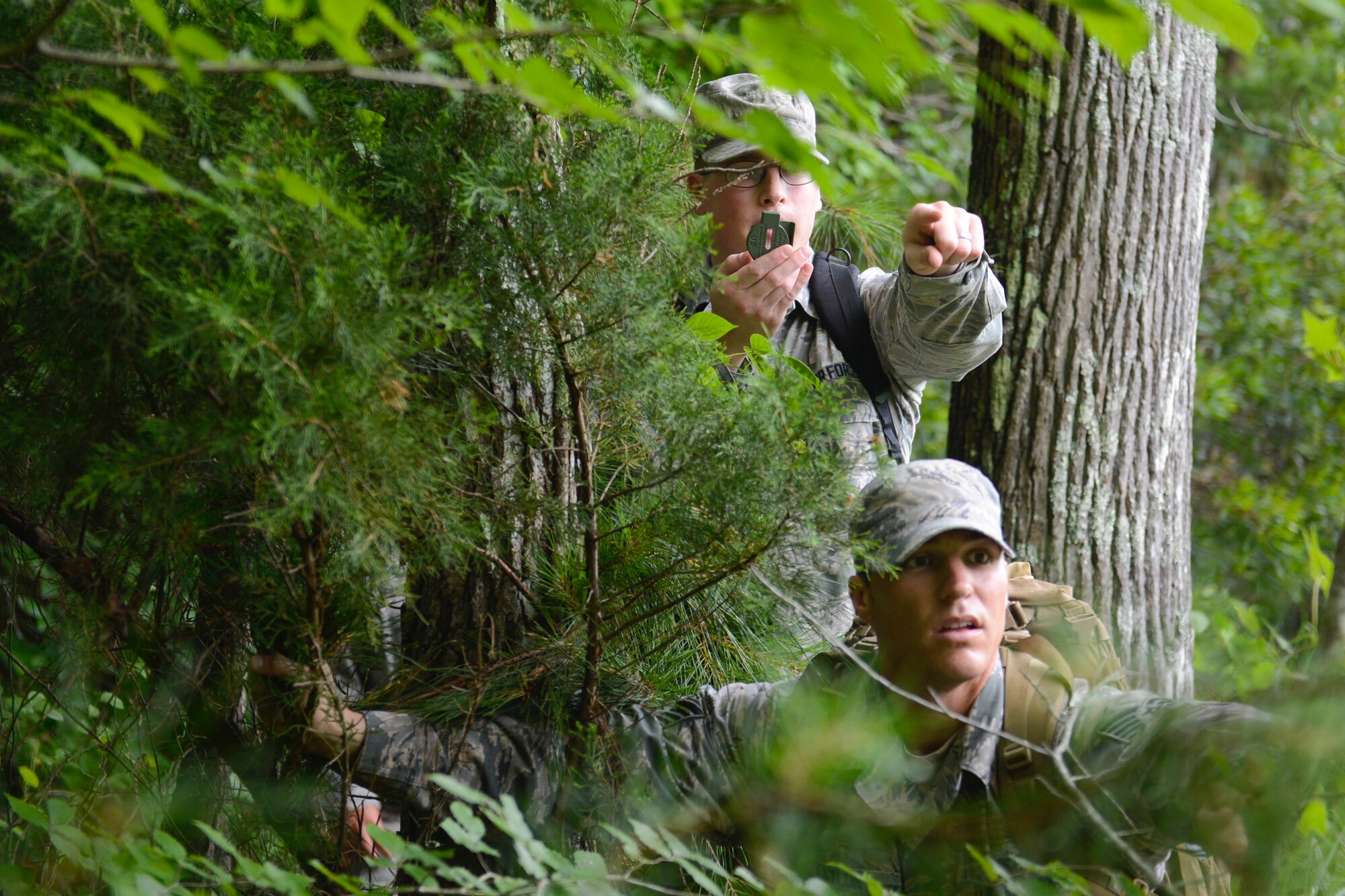U.S. Air Force Staff Sgt. Matthew Milavickas, left, 633rd Civil Engineer Squadron pavement and construction equipment craftsman, and Tech. Sgt. Matthew Lawrence, 633rd Civil Engineer Squadron NCO of explosive ordnance device training, search for a designated location during a Prime Base Engineer Emergency Force land navigation training at Joint Base Langley-Eustis, Va., June 15, 2017. The 633rd CES Airmen perform Prime BEEF training every month to establish and maintain deployment readiness. (U.S. Air Force photo/Airman 1st Class Kaylee Dubois)
