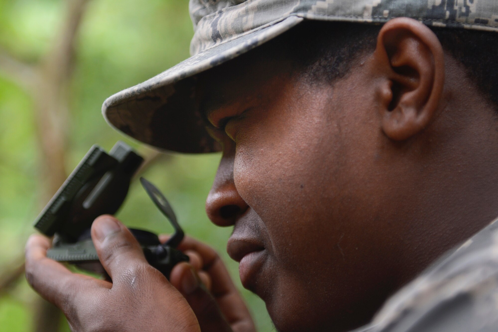 U.S. Air Force Senior Airman Patrick Marvel, 633rd Civil Engineer Squadron pavement and construction equipment craftsman, uses a compass during a Prime Base Engineer Emergency Force land navigation training at Joint Base Langley-Eustis, Va., June 15, 2017. During the training Airmen were provided maps, compasses and protractors to find a designated location within a one hour time limit. (U.S. Air Force photo/Airman 1st Class Kaylee Dubois)