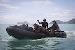 Sgt. Antuan D. Martin, lead instructor of Raider Reconnaissance Operator Course, instructs Marines on amphibious operations during an exercise aboard Marine Corps Training Area Bellows, June 15, 2017. Martin demonstrated how to safely launch and beach their Zodiac inflatable craft with several surf passage exercises.