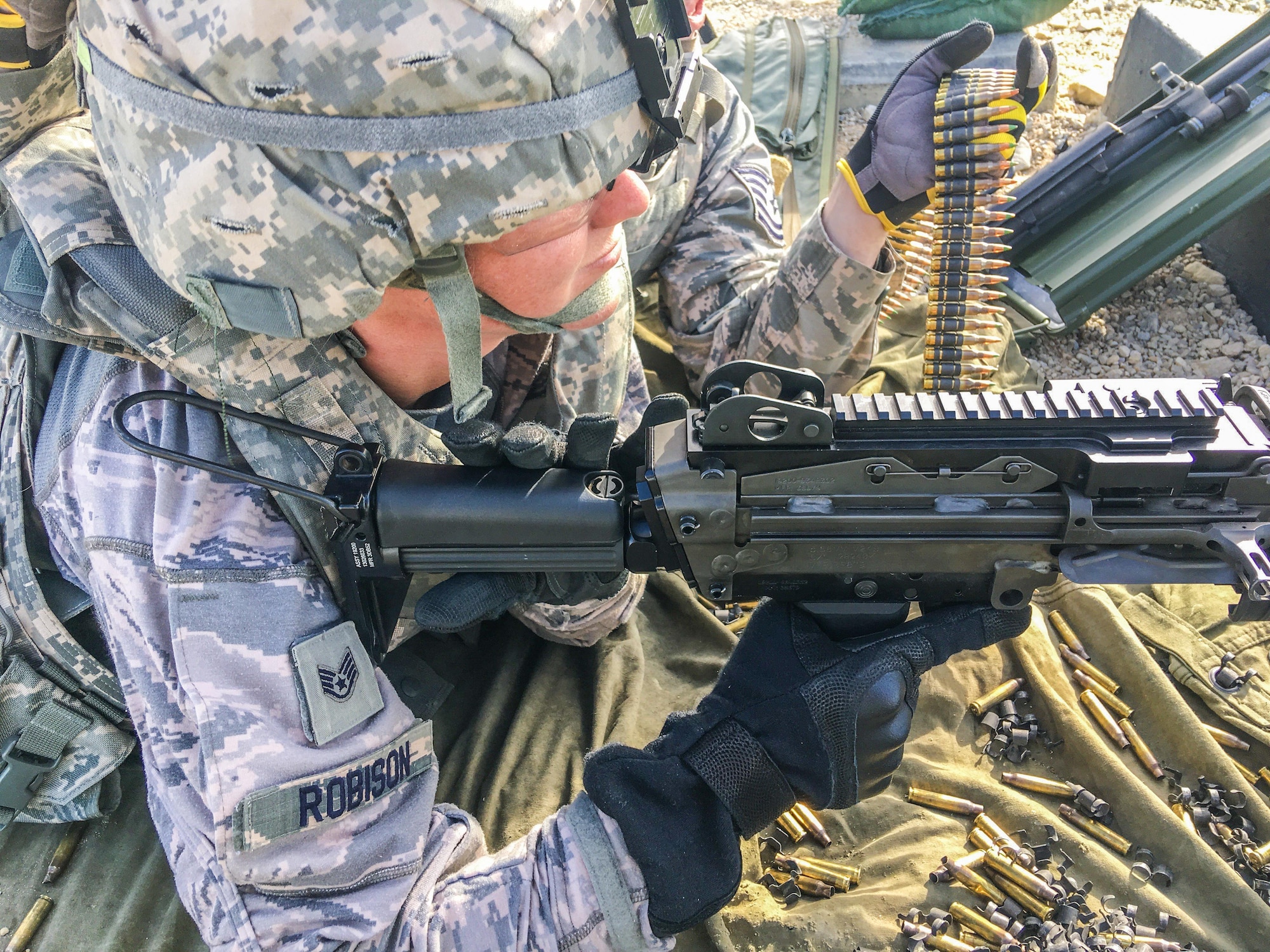 U.S. Staff Sgt. Amber Robison, with the 139th Security Forces Squadron, Missouri Air National Guard, prepares to fire a M249 light machine gun, during a live-fire training exercise at Fort Riley, Kan., June 7, 2017. The live-fire machine gun training is an annual requirement for members of security forces and support personnel. (U.S. Air National Guard photo by Staff Sgt. Troy Green)