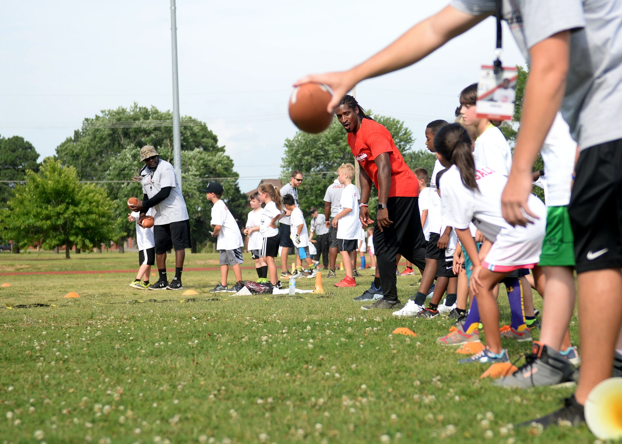 Andre Roberts, an Atlanta Falcons wide receiver and former military child, teaches a football drill during the Proctor & Gamble Andre Roberts Football ProCamp June 16, 2017, at Little Rock Air Force Base, Arkansas. All Defense Commissary Agencies participated in a competition to win the event for their bases, and the ones with the most support from the community were awarded a ProCamp. (U.S. Air Force photo by Airman 1st Class Codie Collins)