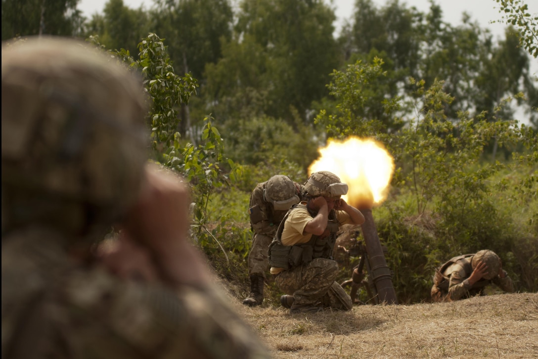 A U.S. soldier, foreground, observes as Ukrainian soldiers assigned to the 1st Airmobile Battalion, 79th Air Assault Brigade fire a mortar during a live-fire exercise at the Yavoriv Combat Training Center near Yavoriv, Ukraine, June 16, 2017. The U.S. soldier is assigned to the Oklahoma Army National Guard's 45th Infantry Brigade Combat Team. Army photo by Staff Sgt. Eric McDonough
