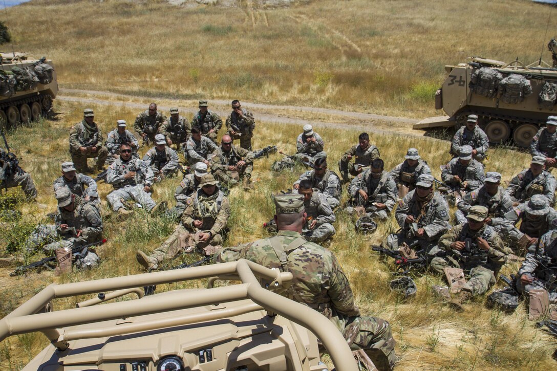 U.S. Army Command Sgt. Maj. Ted Copeland, United States Army Reserve Command (USARC) Command Sgt. Maj., addresses soldiers from the 374th Sapper Co. from Concord, Calif., during a lunch break between training iterations as part of the 91st Training Division’s Warrior Exercise (WAREX) 91-17-03 on Fort Hunter Liggett, Calif. on June 12, 2017. After watching their first iteration, Copeland is able to give feedback, address questions, and inform the soldiers about other opportunities that USARC is able to provide them, as they refuel and prepare to reset for another pass of their exercise. (U.S. Army photo by Spc. Sean McCallon, 91st Training Division public affairs/Released)